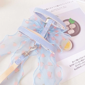 Detail of light blue plaid cat harness with oversized organza peach bow and metal buckle