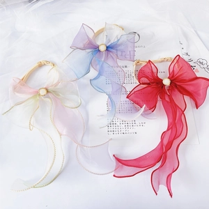 Close-up of pastel organza pet collars with pearls and gold trim for cats and dogs