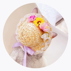 Detail view of woven pet straw hat featuring white lace trim and colorful floral accents