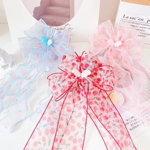 Close-up of three cute bow ties with wings in blue, pink, and cherry patterns