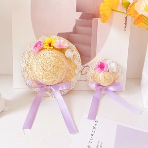 Detailed view of handwoven pet straw hats with lace edges and colorful floral accents