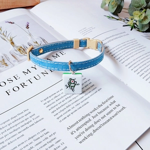 Detail of denim pet collar with unique Mahjong pendant and sturdy plastic buckle