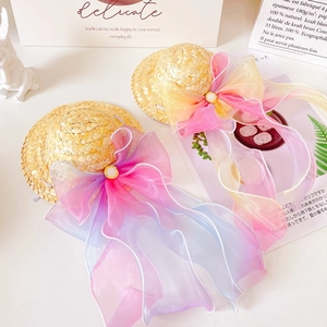 Detail of pet straw hat with large gradient organza bow and pearl ornament