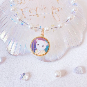 Detail of pet pearl collar with iridescent heart beads and cute cat portrait pendant