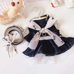 Detail of black satin pet dress with lace trim and matching bow leash set