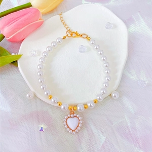 Adjustable pearl pet necklace with a heart pendant and blue sapphire crystal charm