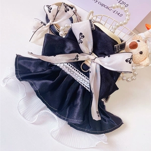 Detail of luxury pet harness dress with black satin, white lace, and large red bow