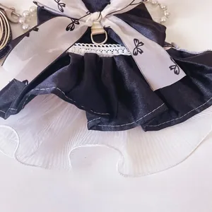 Detailed close-up of soft white mesh layers and black satin fabric with lace trim