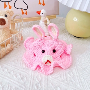 Close-up of handmade pink crochet bunny pet hat with 3D ears and adorable facial features