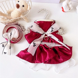 Detail of red pet princess dress with white lace trim and matching leash set
