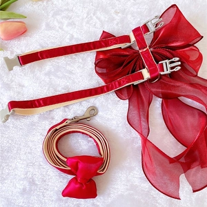 Detail of red pet harness set with large organza bow and adjustable plastic buckles