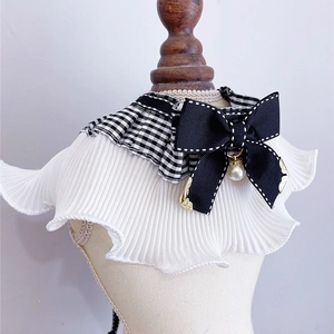 Close-up of pet bib collar with white pleated chiffon, black bow, and pearl pendant