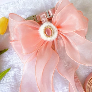 Detail of luxury pink organza bow pet harness with pearl opal center and plush trim