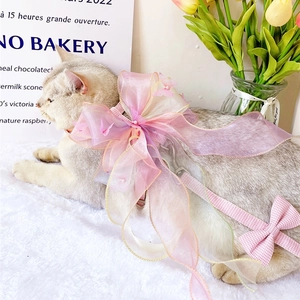 Detailed view of pink organza bow harness with butterfly accents and plaid leash for pets