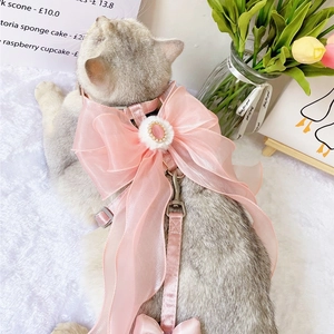 Detail of pink pet harness featuring large organza bow and pearl gemstone embellishment
