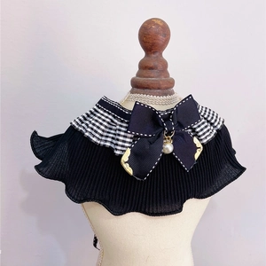 Detail of pet collar with black pleated lace, checkered ruffle, and bow with pearl charm