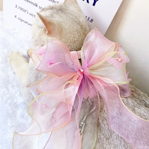 Detail of pet harness featuring pink purple gradient organza bow with pearl accents