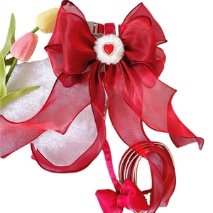 Red pet harness featuring large organza bow, heart crystal, and retractable leash set