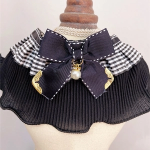 Detail of pet collar with black gingham ruffles, large bow and pearl pendant