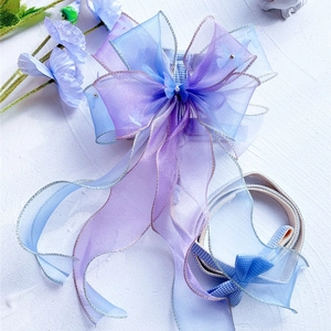 Detail of blue gradient organza butterfly bow pet harness with a small pearl and silver glitter edge