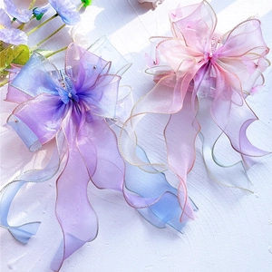 Detail of fairy-style pet harness with layered organza bows and pearl butterfly charms