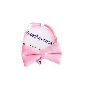 Pink velvet pet collar with a large bow and bell on a white display card for small dogs