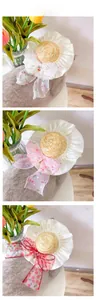 Detailed view of woven pet straw hat with cherry print chiffon bows for cats and small dogs