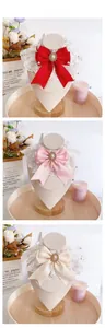 Detailed close-up of lace pet collars with satin bows, pearls and sparkling rhinestones