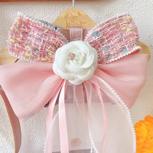 Pink tweed dog harness with white camellia flower, bow, and elegant pearl tassels