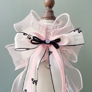 Detail of multi-layer organza bow on pet harness with beads and butterfly patterns