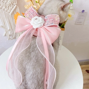 Detailed view of pink tweed bow with camellia flower and chiffon ribbons on dog harness