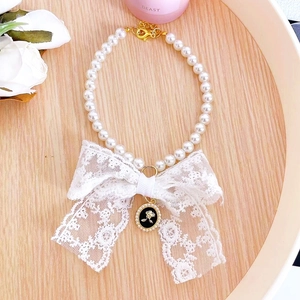 Elegant pet pearl collar with white lace bow and vintage golden floral pendant