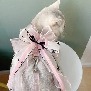 Detail of floral bow pet harness with pink organza and black metal D-ring attachment