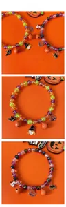 Detail of Halloween pet beaded necklaces with pumpkin and bat charms on orange background