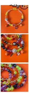 Detail of Halloween pet necklace with pumpkin charms and colorful iridescent beads
