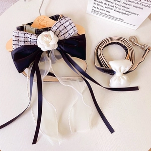 Detail of dog harness with camellia flower, pearl tassels and black silk bow decoration