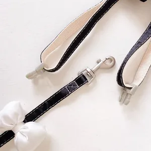 Detail of premium silver metal rotating hook and bowknot on pet harness strap