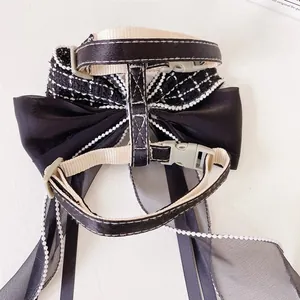 Adjustable pet harness with black silk bow and tweed texture, back view detail display