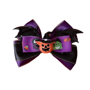 Halloween pet bow tie featuring purple ribbons, bat wings, and a pumpkin with a wizard hat