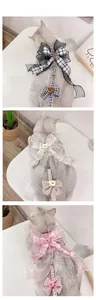 Close-up of adjustable pet harnesses featuring plaid patterns, bows, and cute bear motifs