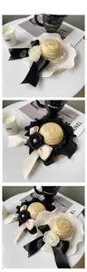 Close-up of luxury pet straw hat with silk bow and pearl accents for cats and dogs