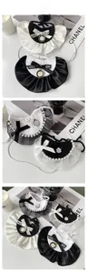 Detail of luxury pet lace collar with pearls, satin ribbons and camellia flower pendant