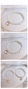 Close-up of pearl pet necklace with heart gemstone pendant in pink and white styles