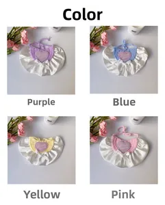 Detail of crochet pet bibs in purple, blue, yellow, and pink with heart embroidery