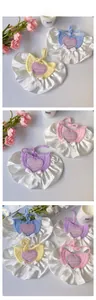 Detail of crochet pet bib featuring satin bow and Love Cookie heart embroidery