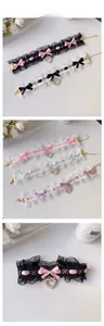 Detail of lace pet collar featuring satin bows and pearl heart charms in various colors
