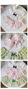 Detail of pet lace collar with organza ruffles, satin bow and heart crystal pendant