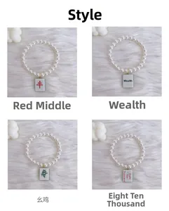 Detail of four pet pearl necklaces with traditional Chinese Mahjong pendants on white fur
