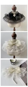 Close-up of lace mesh pet collar with polka dots, large bow and heart pearl button