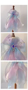 Detailed macro view of the multi-layer organza bow with blue gemstone and pearls
